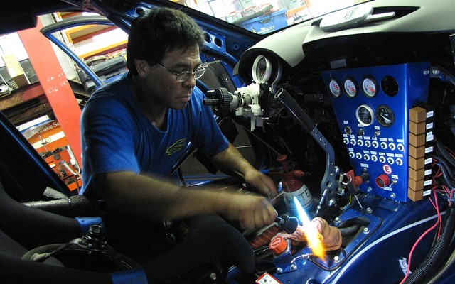 Chief mechanic Stewart Hoo modifying the Targa STI's shift lever