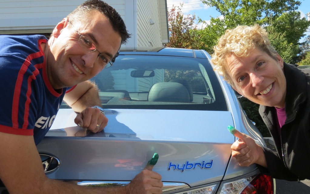 One "Blue Drive" hybrid car, two green thumbs.