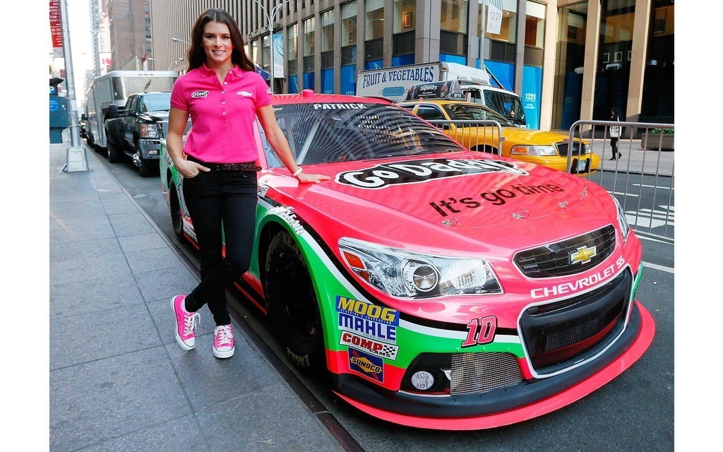 Danica Patrick next to her new pink Chevrolet