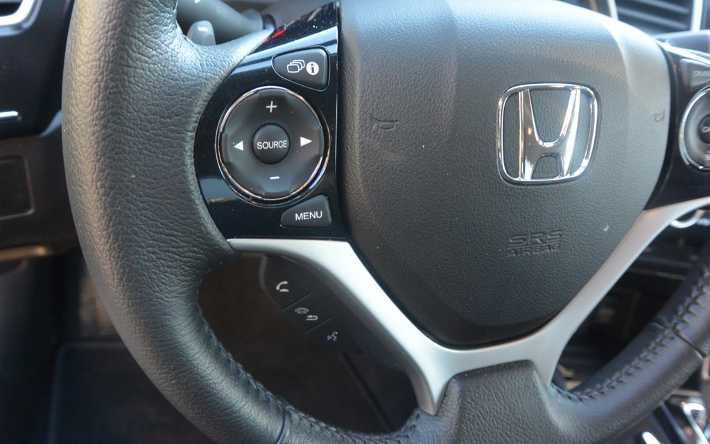 The button behind the steering wheel is used to control the sound system.