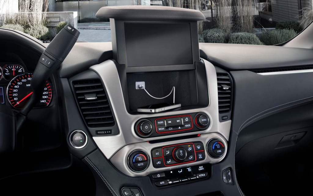 A pop-up touchscreen reveals a secret storage compartment inside the Yukon.