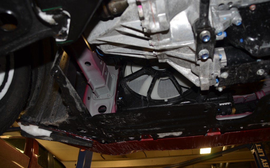 A view of the radiator fan and a portion of the unpainted chassis. 