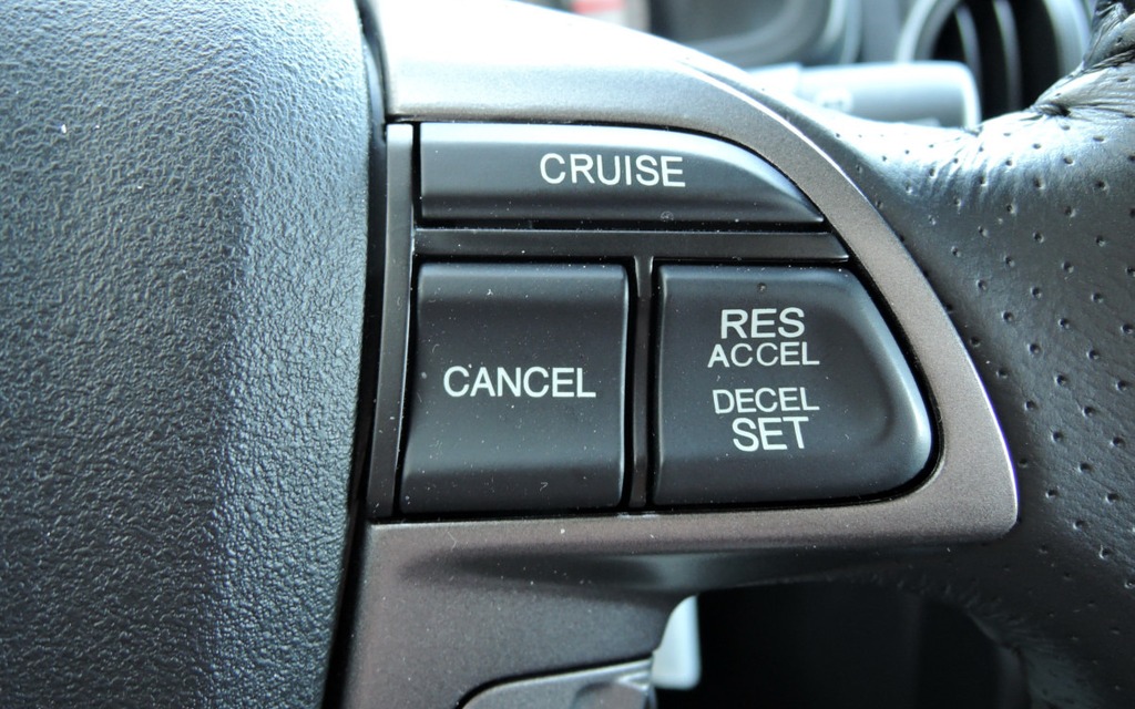 Right spoke of the steering wheel: Cruise control buttons.