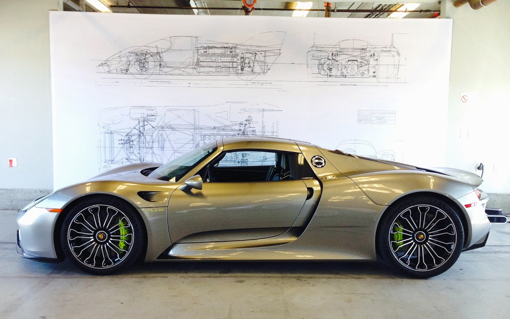 One of the 918s in front of some technical drawings for the 917.