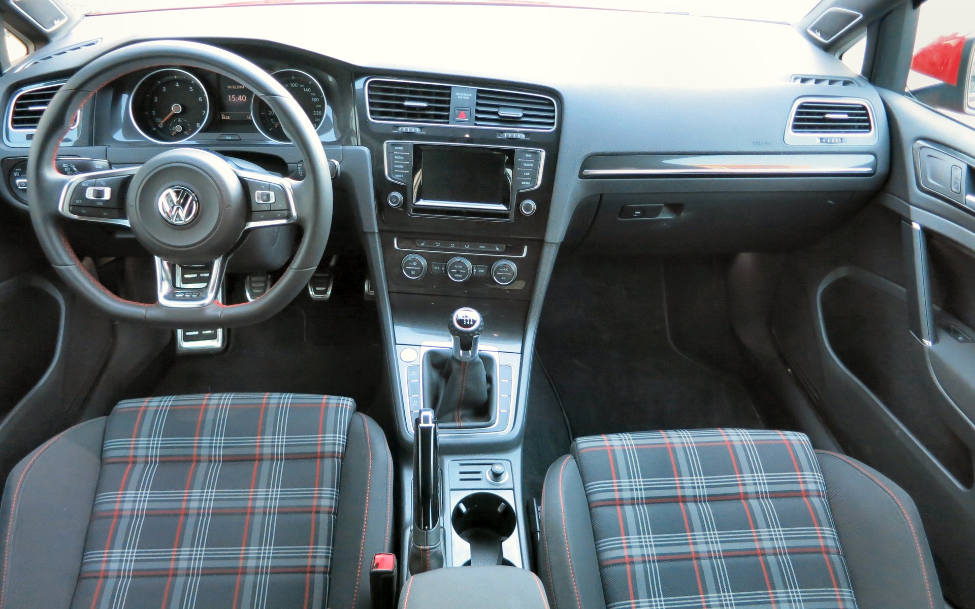 The new VW Golf GTI maintains its trademark plaid cloth upholstery.