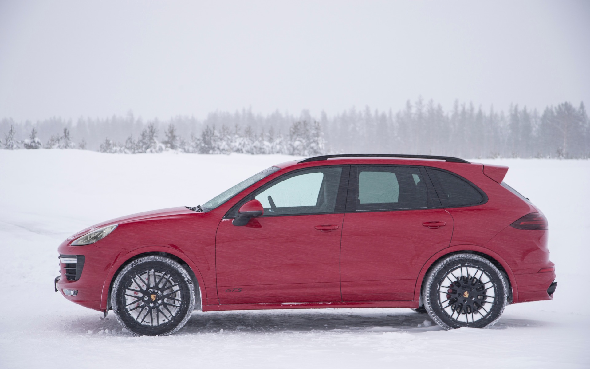 Black openwork rims loaded with snow.