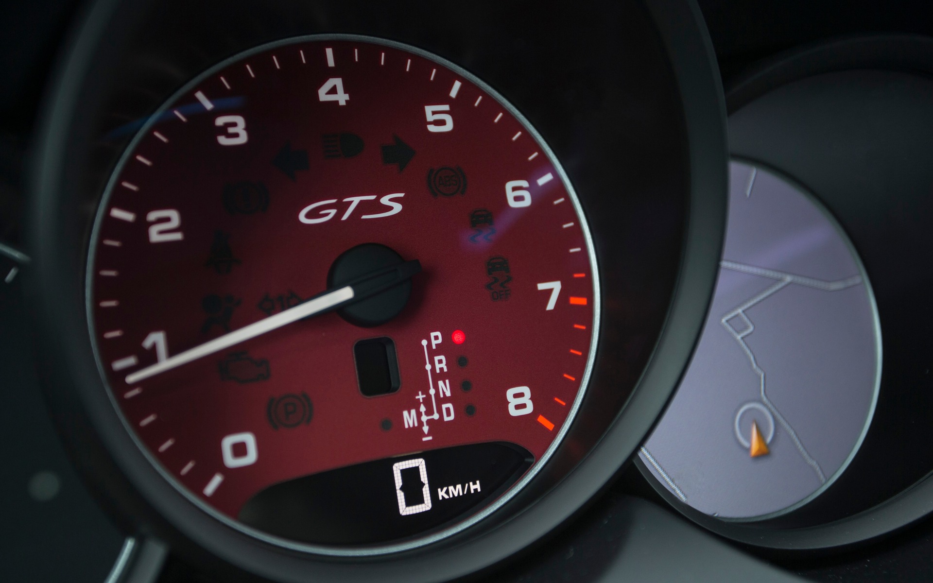 Close-up of the rev counter with red background.