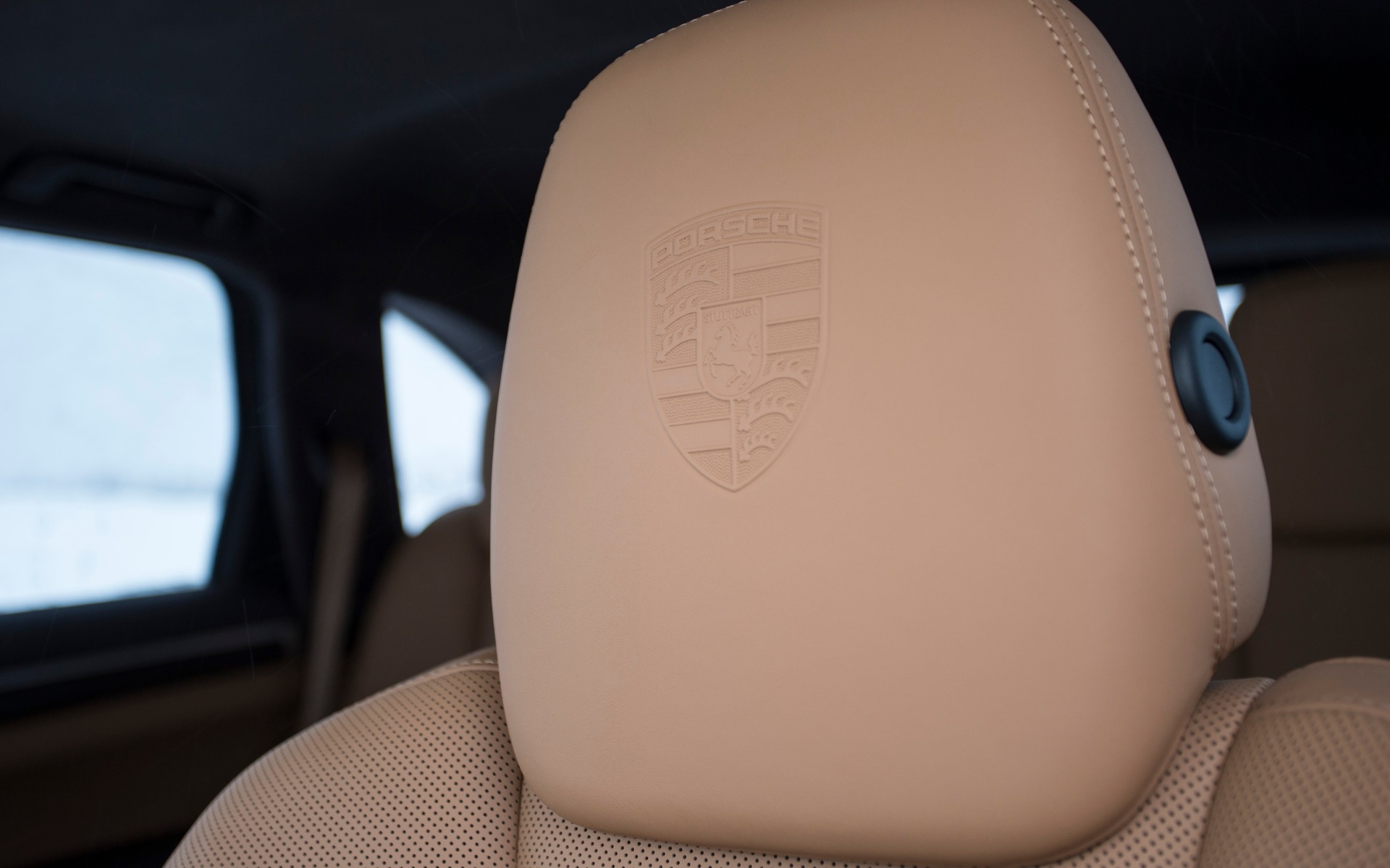 Porsche logo embossed in the headrests.