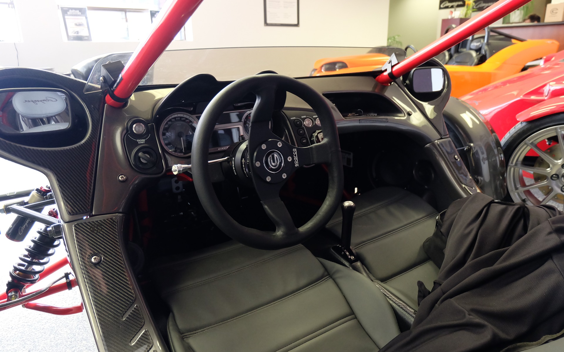 The barebones interior is enhanced by a leather-covered steering wheel.