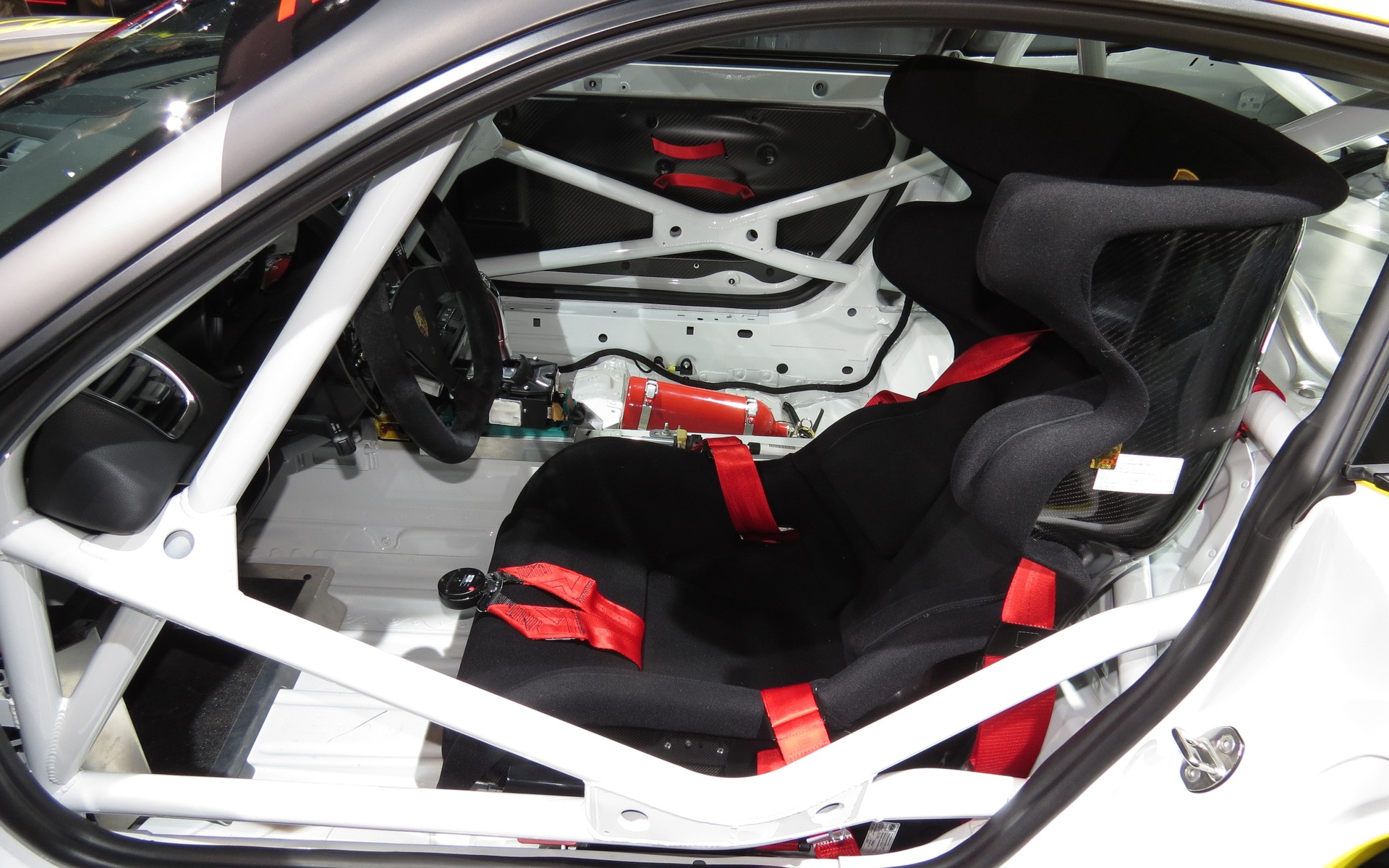 The deep racing seat, six-point seat belt and safety cage.