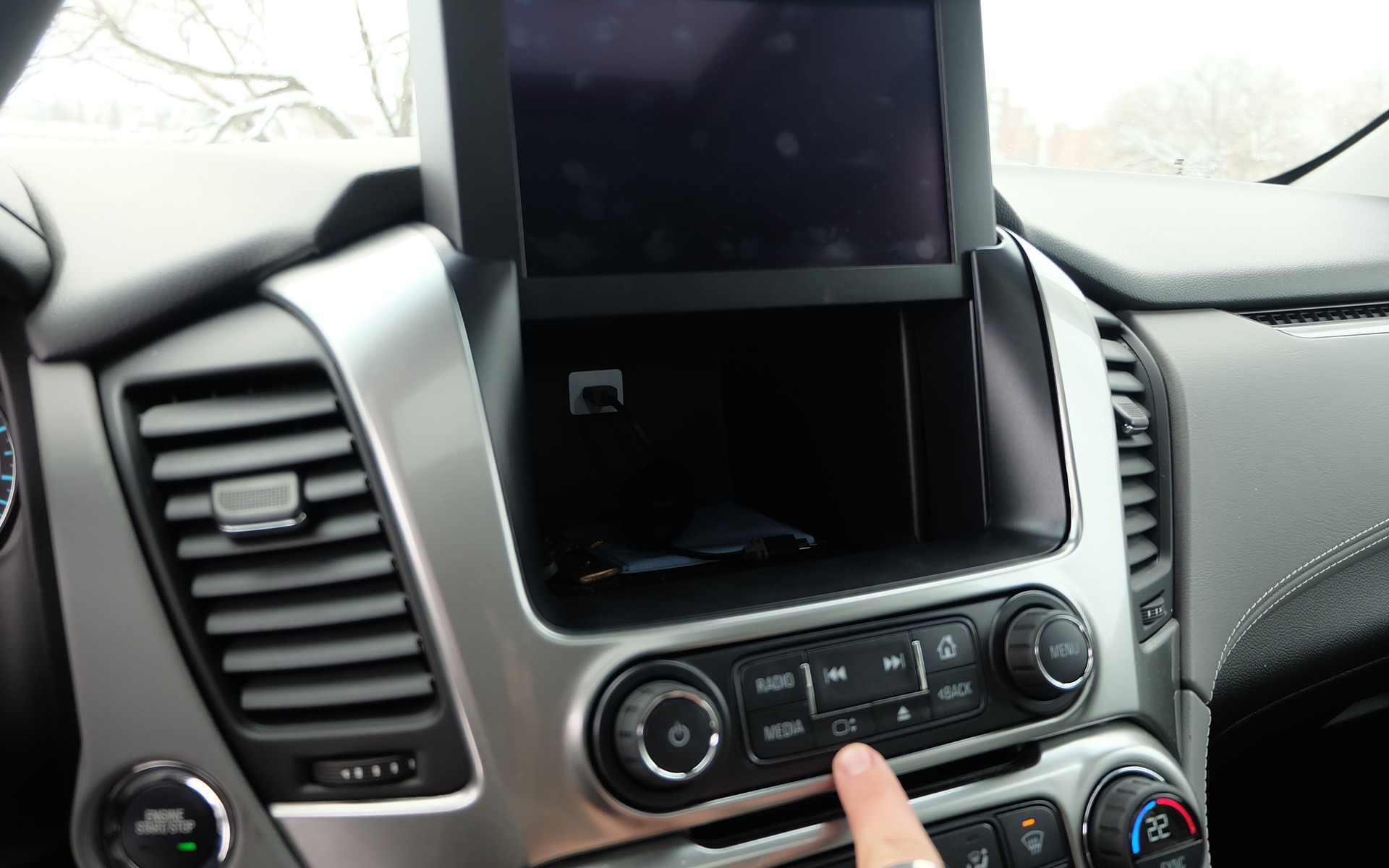 It opens a hidden storage compartment, complete with a USB socket!