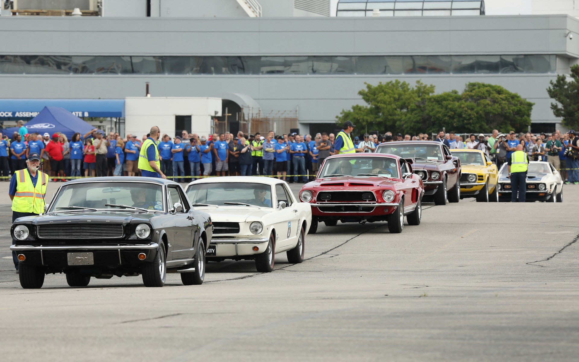 <p>Parade of Ford Mustang models representing all six generations</p>